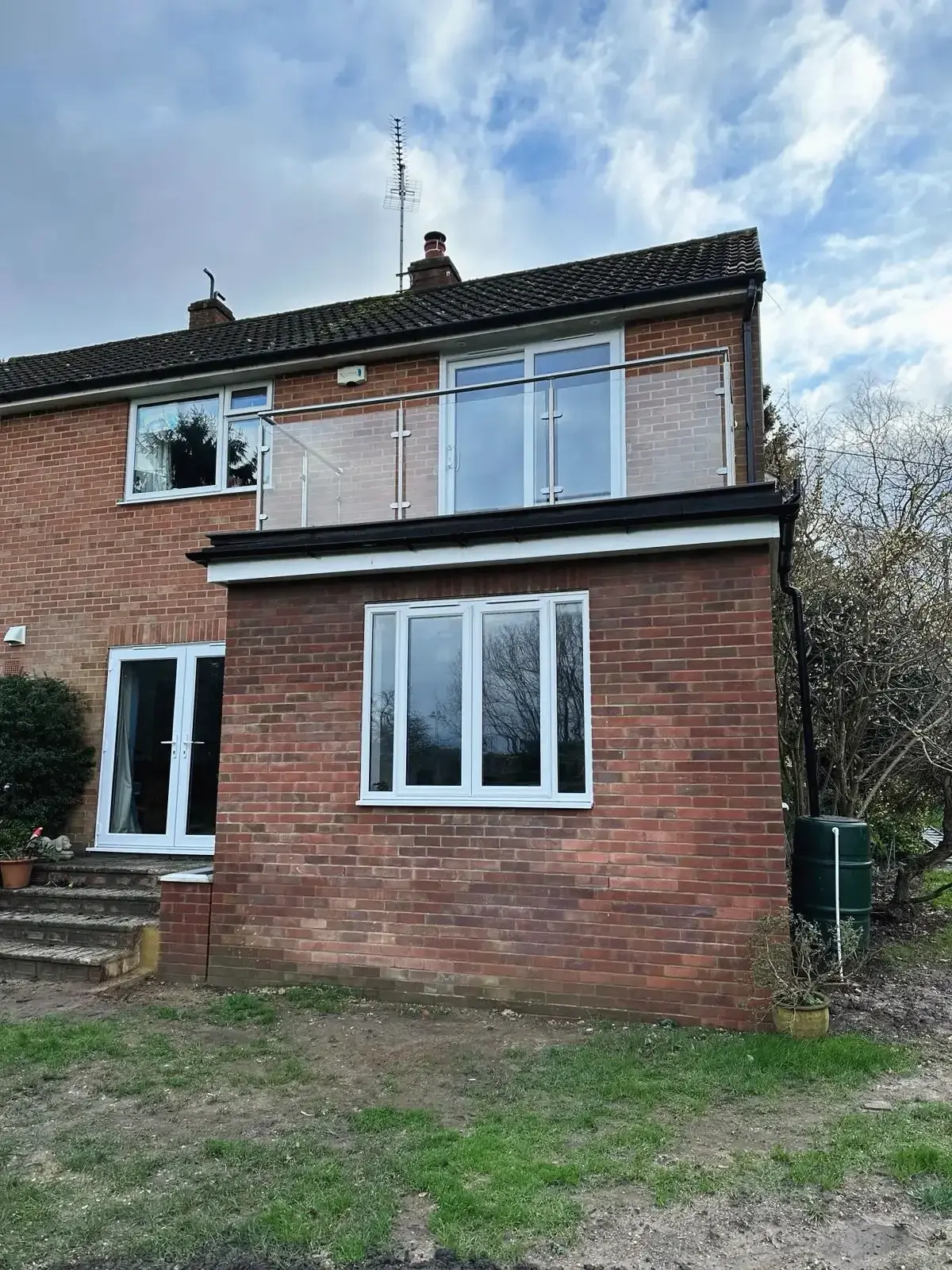 Brick house with a new single-storey rear extension and replacement windows