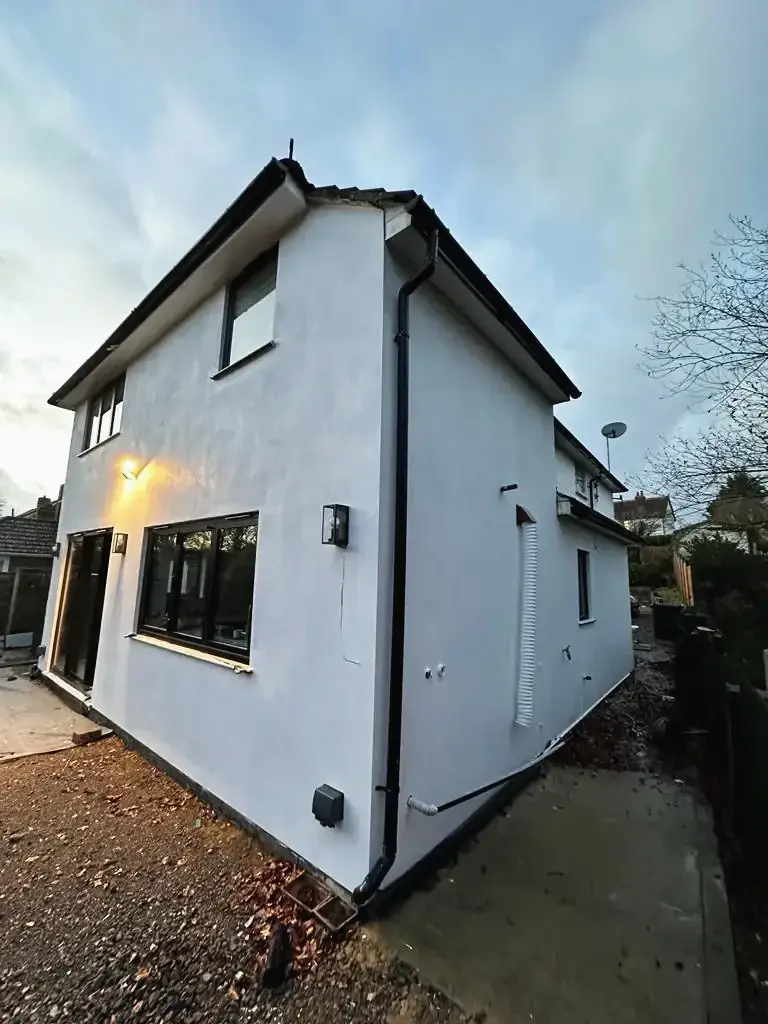 Exterior renovation with a smooth white render finish