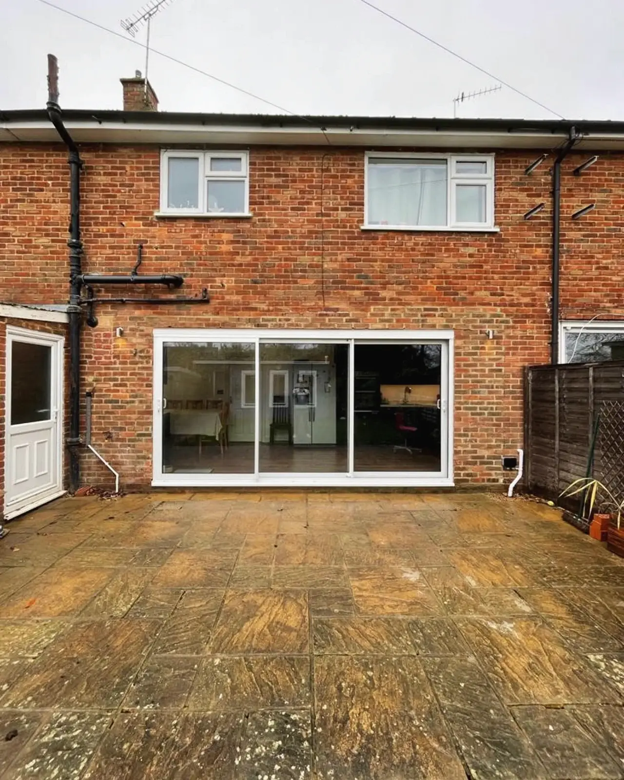 The same house after renovation, with wide sliding doors across the back