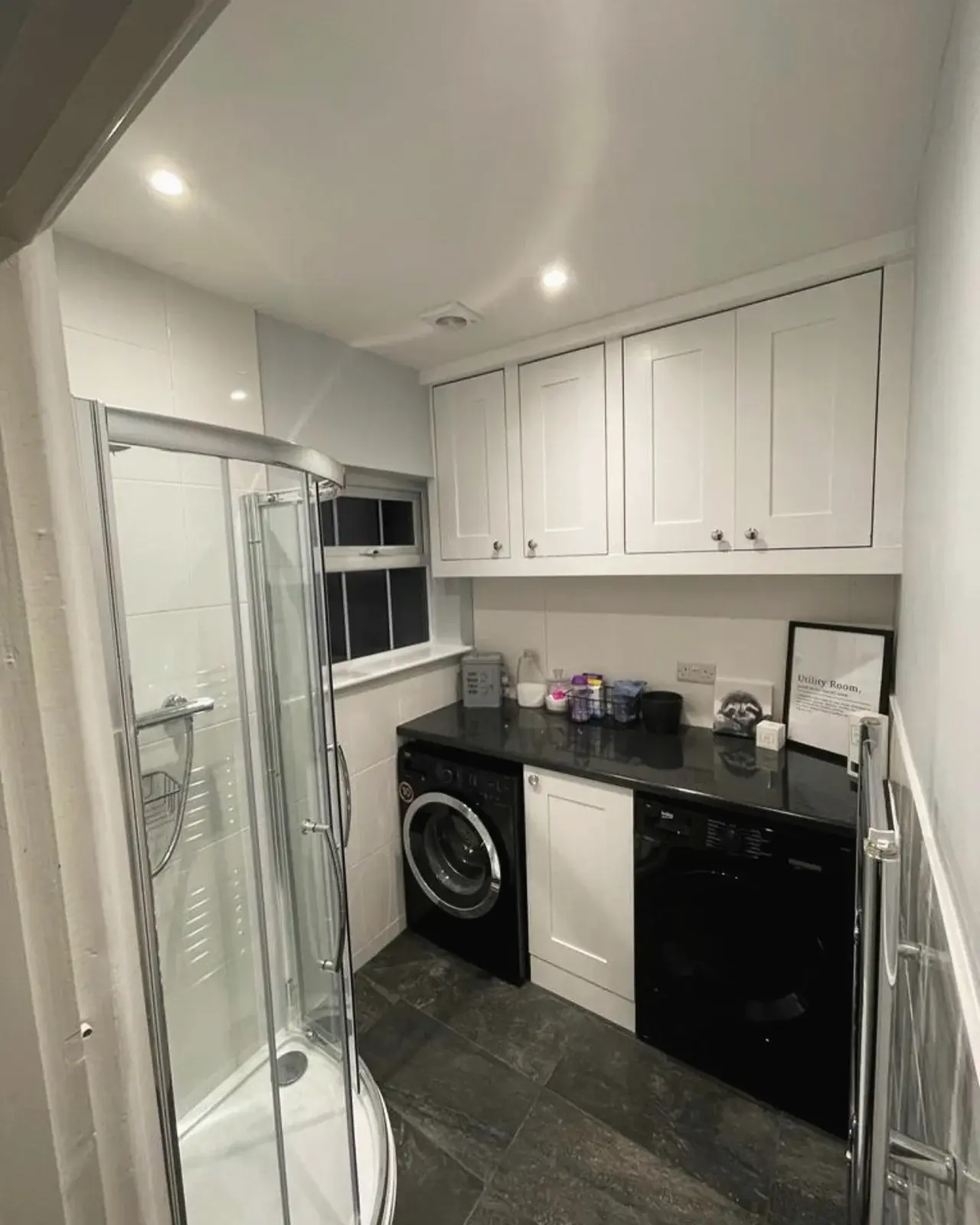 Renovated shower and utility room with fitted cupboards and laundry space