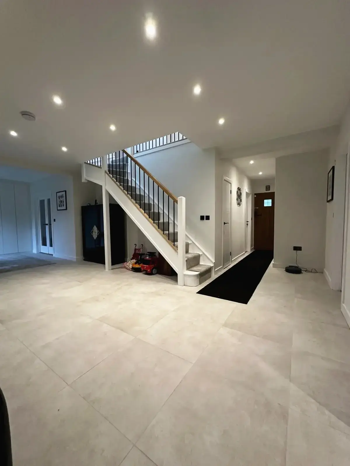 Renovated hallway and staircase opening onto an open-plan living space